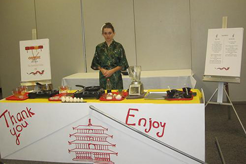 A person stands at an Asian-style table for egg preparation